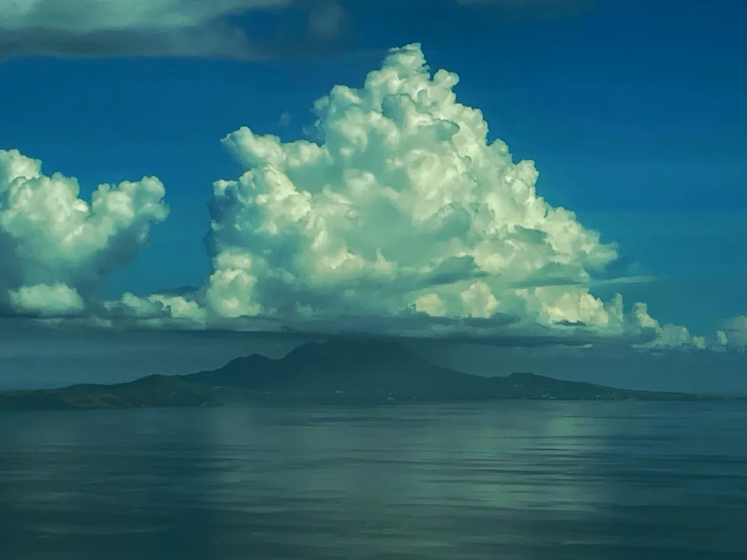 A cloud forming over an island