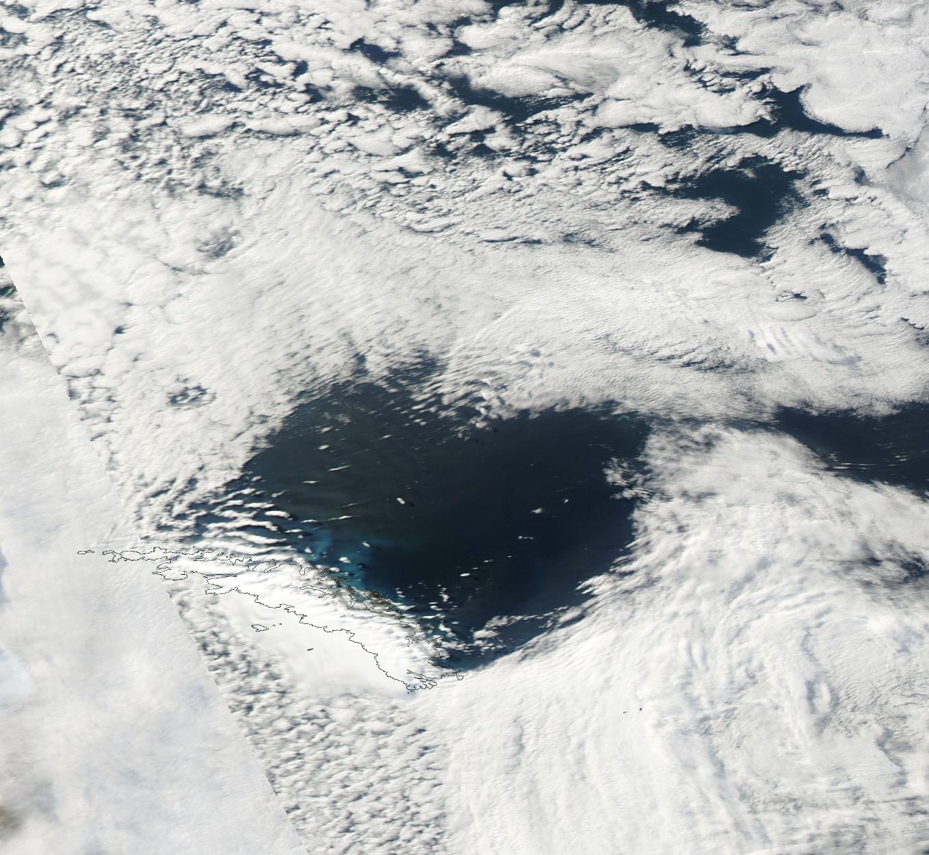 A region of less cloud downwind of a mountainous island