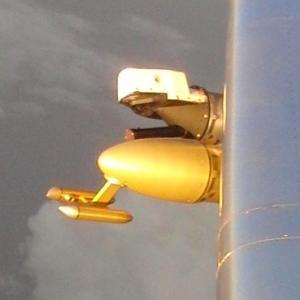 A gold-coloured set of metal prongs on the wing of an aircraft